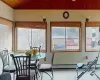 Sunroom featuring vaulted ceiling and a healthy amount of sunlight