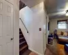 Staircase with baseboards, a ceiling fan, and carpet