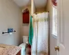 Primary Full bathroom with a wealth of natural light, curtained shower, toilet, and vanity