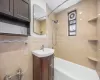 Full bathroom with vanity, tile walls, and shower / bathtub combination