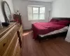 Bedroom featuring baseboards and wood finished floors