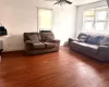 Living room featuring ceiling fan, baseboards, and wood finished floors