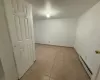 Unfurnished room featuring light tile patterned floors, baseboards, and baseboard heating