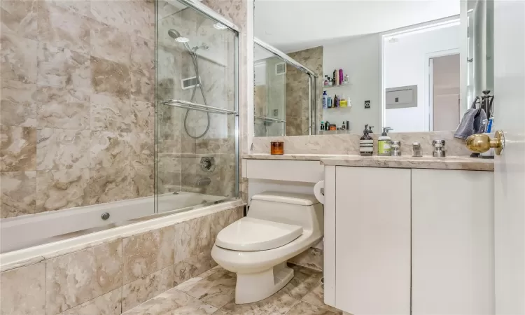 Full bath with vanity, tiled shower / bath, and toilet