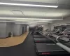 Workout area featuring wood finished floors