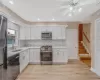 Kitchen featuring a sink, light wood-type flooring, appliances with stainless steel finishes, and light countertops