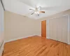 Unfurnished bedroom featuring a closet, radiator, light wood-type flooring, and baseboards