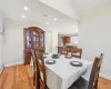 Dining space featuring recessed lighting, light wood-style flooring, baseboards, and vaulted ceiling