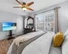 Bedroom with ceiling fan, baseboards, and wood finished floors