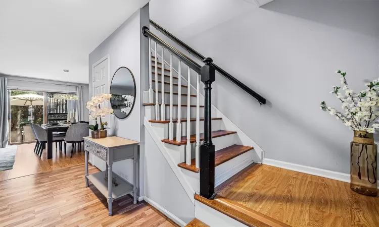 Staircase featuring baseboards and wood finished floors