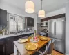 Kitchen with a sink, dark brown cabinets, appliances with stainless steel finishes, and light countertops