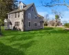 View of property exterior with a yard and a chimney