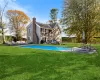 View of swimming pool featuring a patio, a yard, and a fenced in pool