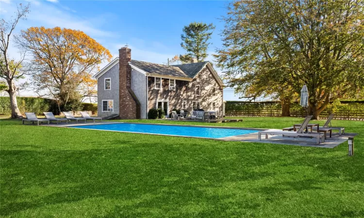 View of swimming pool featuring a patio, a yard, and a fenced in pool