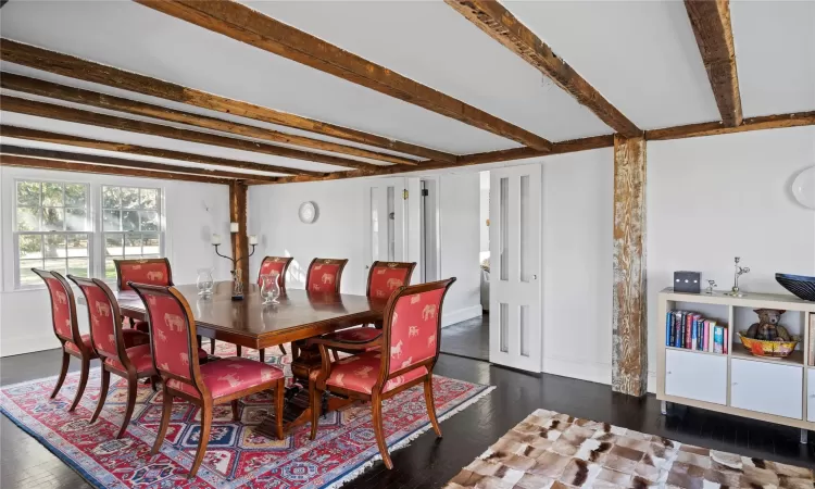 Dining space featuring beamed ceiling, wood finished floors, and baseboards