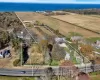 Birds eye view of property featuring a rural view and a water view