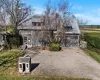 View of front of house featuring a barn, an outdoor structure, and a front yard