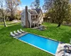 Outdoor pool with a yard, a patio area, and fence