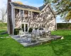 Rear view of house with a patio, cooling unit, fence, a yard, and a chimney