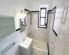 Full bathroom featuring tile walls, vanity, and bathtub / shower combination