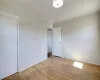 Unfurnished bedroom featuring baseboards, hardwood / wood-style floors, and crown molding