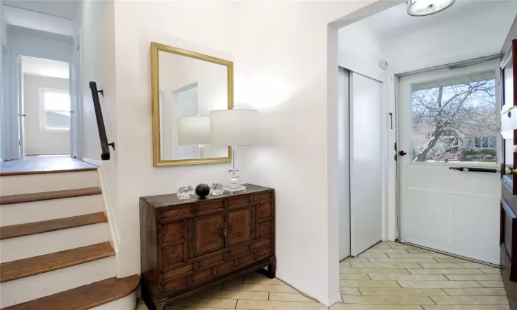 Foyer entrance with stairs and ornamental molding