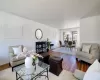 Living room with a notable chandelier, wood finished floors, and baseboards