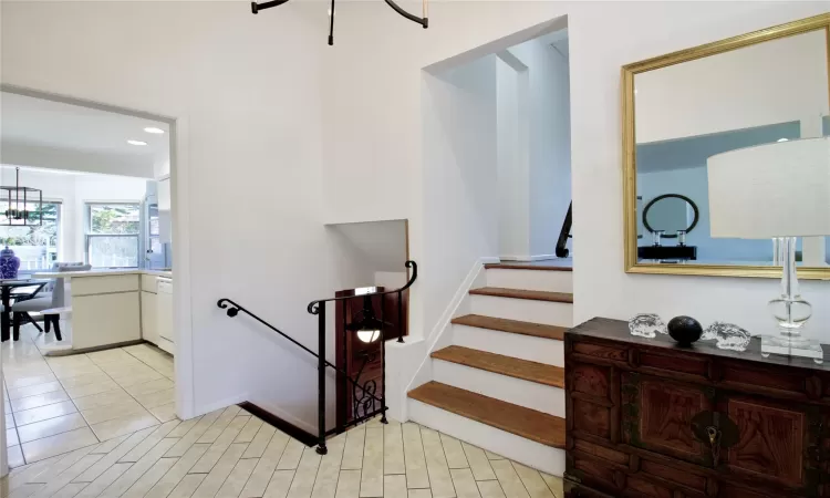 Stairway featuring an inviting chandelier, recessed lighting, and tile patterned floors