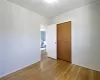 Unfurnished bedroom featuring a closet, light wood-style flooring, baseboards, and ornamental molding