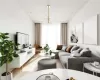 Living room with an inviting chandelier, a healthy amount of sunlight, and light hardwood / wood-style floors