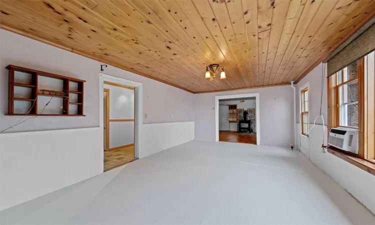 Spare room featuring crown molding, cooling unit, and wood ceiling