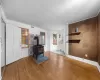 Entryway with hardwood / wood-style floors, a wood stove, and visible vents