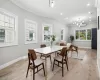 Dining area featuring baseboards, light wood finished floors, and ornamental molding