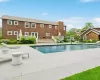 Outdoor pool with a wooden deck and a patio