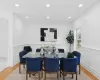 Dining space with recessed lighting, a wainscoted wall, and wood finished floors