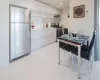 Kitchen featuring under cabinet range hood, appliances with stainless steel finishes, modern cabinets, and a sink