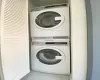 Clothes washing area with laundry area and stacked washer / drying machine