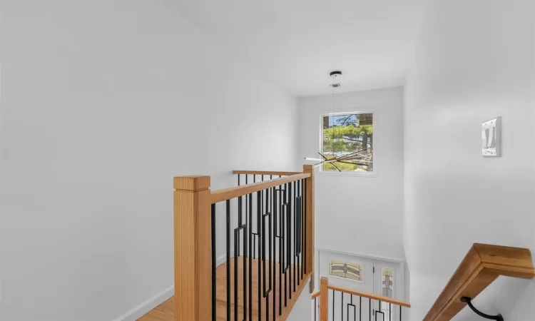 Staircase featuring visible vents, baseboards, and wood finished floors