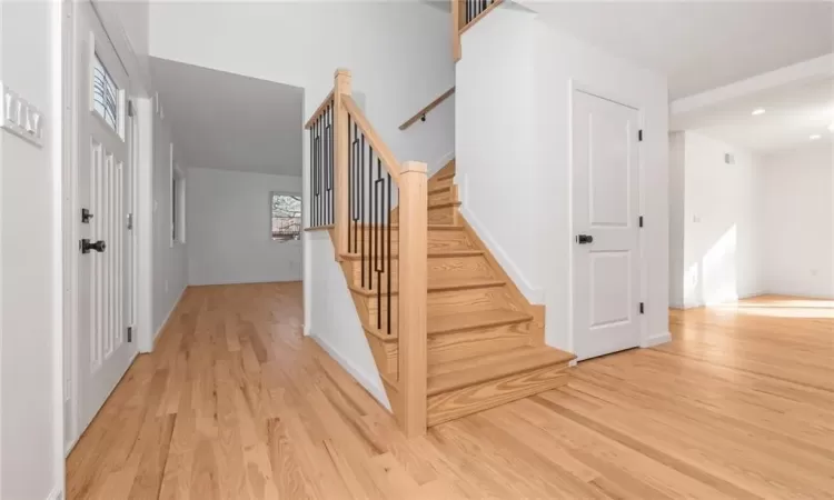 Stairway featuring baseboards and wood finished floors