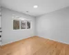 Empty room with visible vents, light wood-style floors, and baseboards