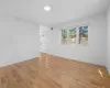 Unfurnished room featuring visible vents, light wood-style flooring, and baseboards