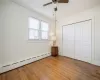 Bedroom 1 on the main level with double closet and wood floors.