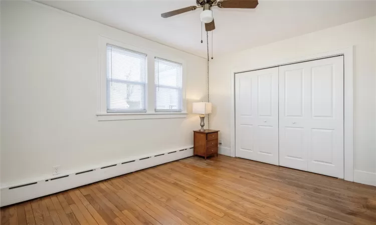 Bedroom 1 on the main level with double closet and wood floors.