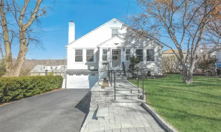 Stone walkway leads you to this Cape Cod home.