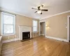 Bright and sunny living room has hardwood floors.