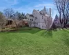 View of the side and back of the house with a spacious side and back yard.