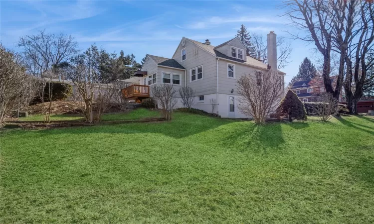 View of the side and back of the house with a spacious side and back yard.