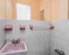 Bathroom with tile walls and a sink