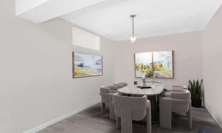 Dining space featuring baseboards and tile patterned flooring