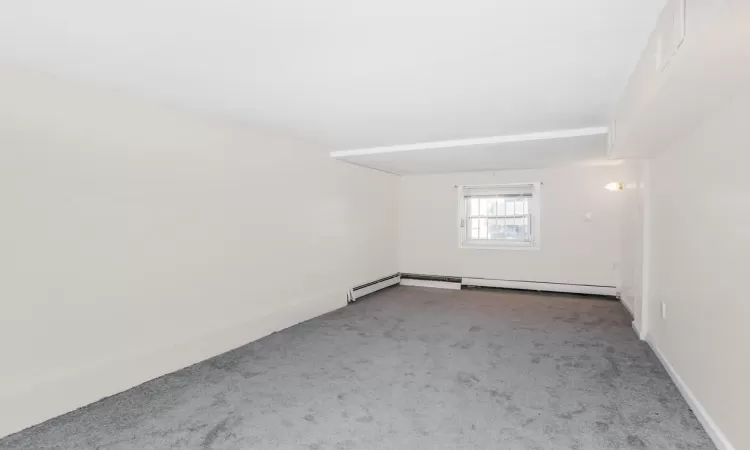 Unfurnished room with baseboards and carpet floors